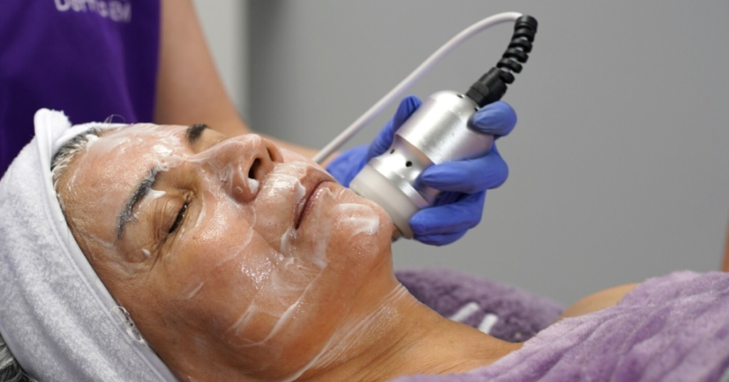 old woman getting treatment with a multifunctional facial machine