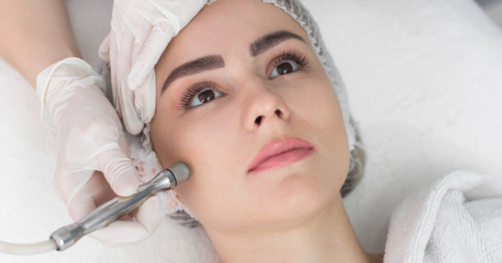 young woman with brown eyes getting microdermabrasion treatment
