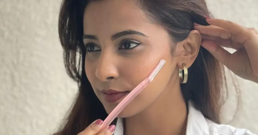 woman holding skincare knife on her cheek