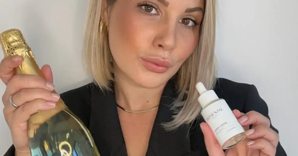 blonde woman holding skin care serum bottle
