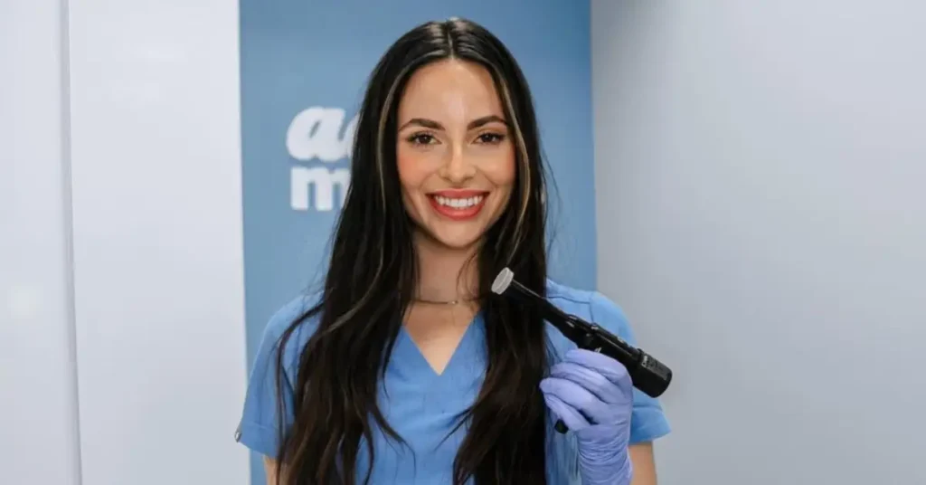 young smiling black haired woman holding microchanneling device