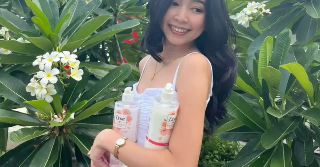 young black haired asian woman holding dove products