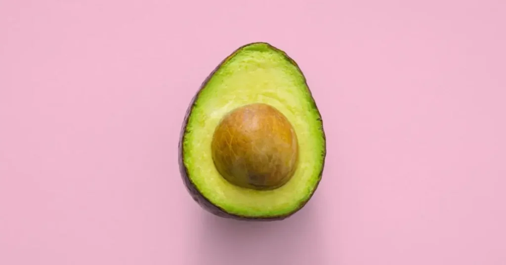 Avocado on pink surface