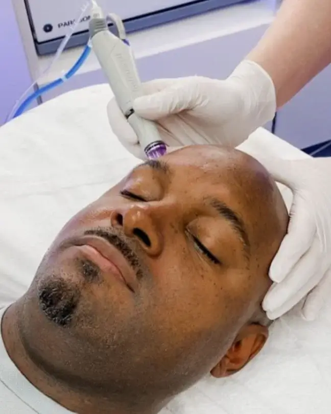 black man getting hydrafacial treatment
