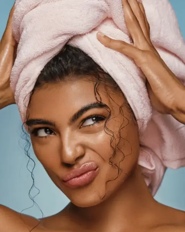 woman with pink towel on her head