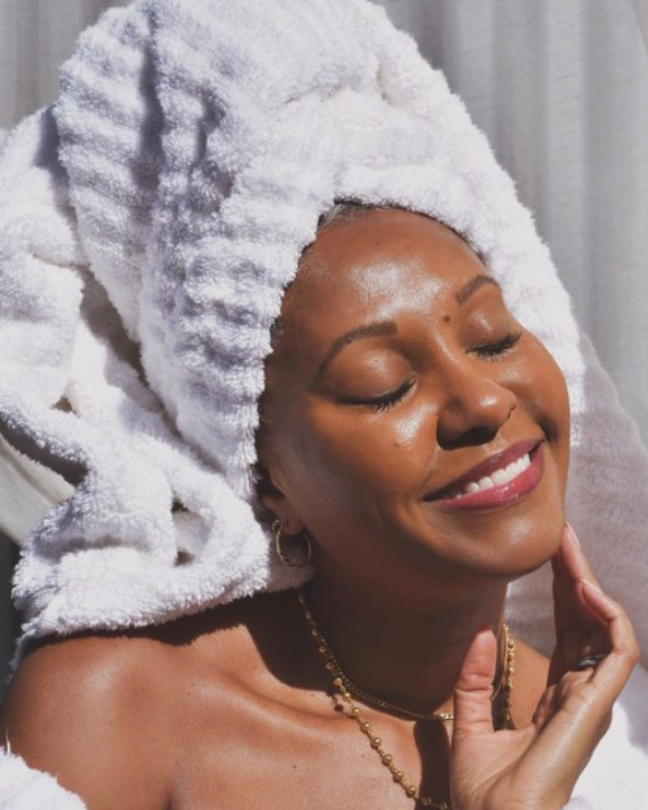 black woman with a white towel on her head