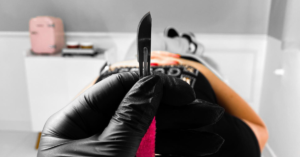 pink dermaplaning knife and a woman
