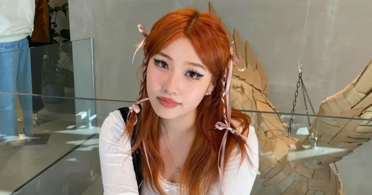 red haired asian woman with red hair and korean makeup