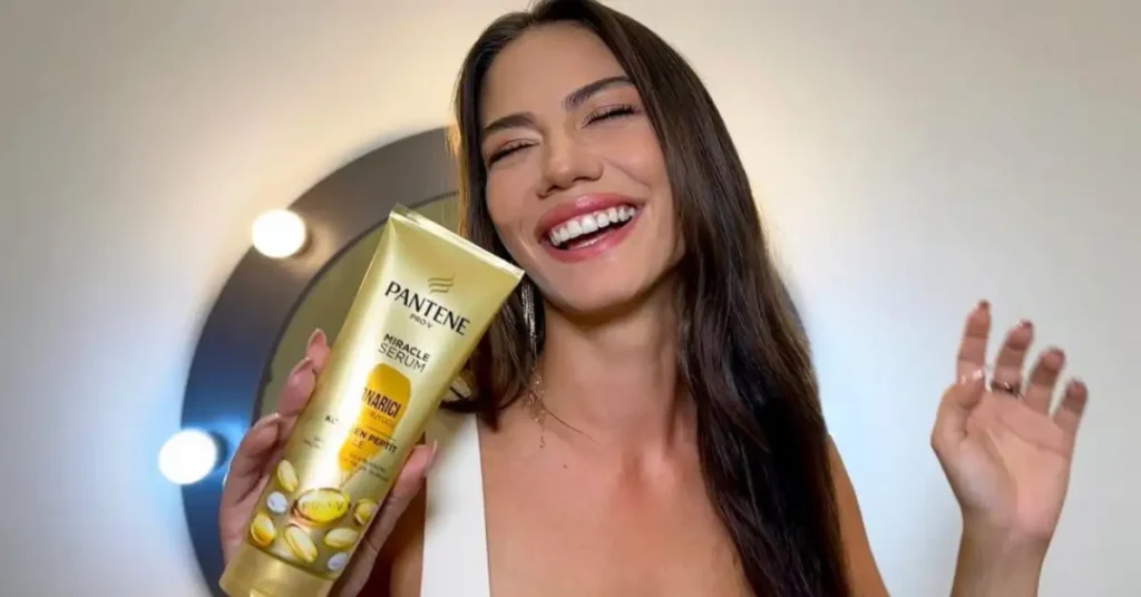 young smiling brunette woman holding pantene miracle serum