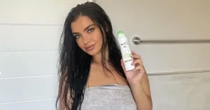 young black haired woman holding dove cucumber deodorant