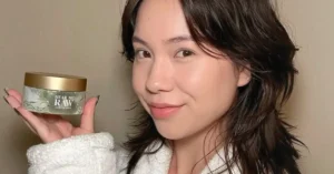 korean woman holding skincare cream