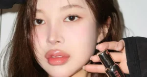 young korean woman holding lip balm